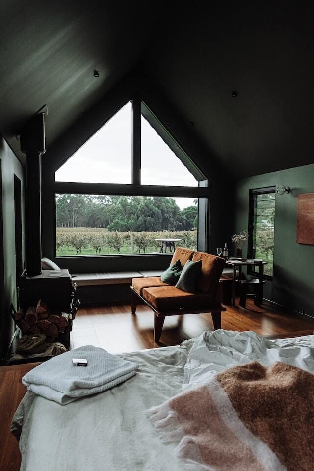 Cozy, green bedroom with large window opening